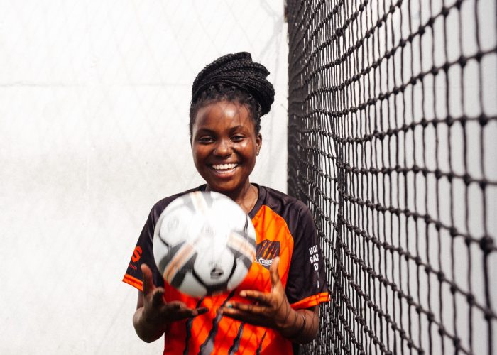 smiling-girl-in-black-and-orange-uniform-holding-soccer-ball-3886257 smiling-girl-in-black-and-orange-uniform-holding-soccer-ball-3886257